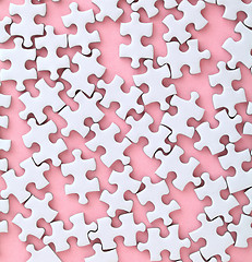 Image showing White jigsaw puzzle on pink background