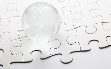 Image showing Glass globe ball with puzzle background