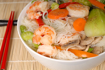 Image showing A bowl of udon noodles with vegetables and seafood closeup