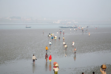 Image showing During low tide the water in the river Malta falls so low that people walk to the other shore in Canning Town, India