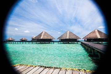 Image showing Over water bungalows with steps into amazing green lagoon