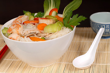 Image showing Udon noodles with vegetables and seafood and spoon