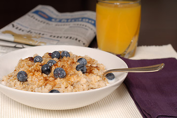 Image showing A bowl of oatmeal with brown sugar and blueberries