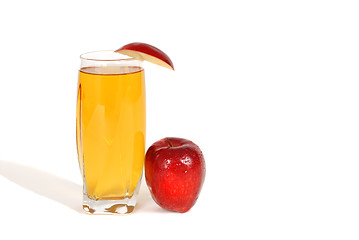 Image showing Glass of apple juice with an apple wedge and apple next to glass