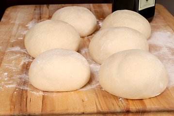 Image showing Six balls of freshly made pizza dough on cutting board