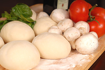 Image showing The makings for a fresh homemade pizza on a cutting board