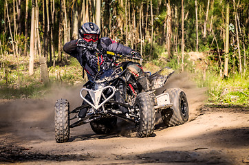 Image showing ATV racer takes a turn during a race. 