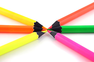 Image showing Neon pencils pointing at each other