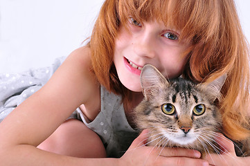 Image showing little girl hugging her cat