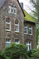 Image showing Old stone house with a mossy roof