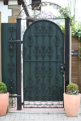 Image showing Ornate green metal entry gate