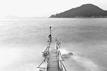 Image showing Old bridge to the sea in black and white