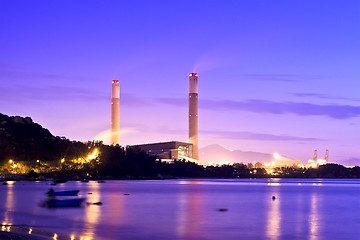 Image showing Power plant along coast at sunset