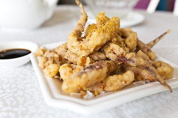 Image showing Plate of fried calamari served with sauce