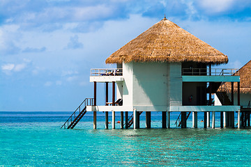 Image showing Over water bungalows with steps into amazing green lagoon