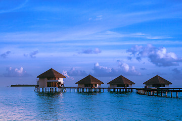 Image showing Over water bungalows with steps into amazing green lagoon