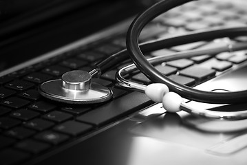 Image showing Stethoscope lying down on an laptop