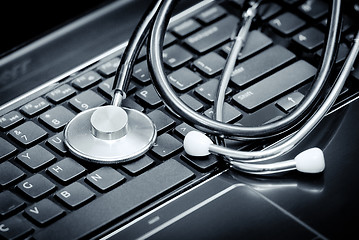 Image showing Stethoscope lying down on an laptop