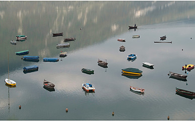 Image showing Embarcations reflecting in a quiet lake