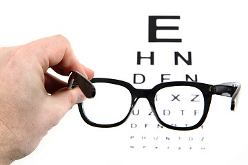 Image showing eye test chart and black glasses