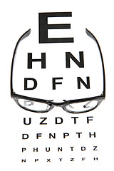 Image showing eye test chart and black glasses