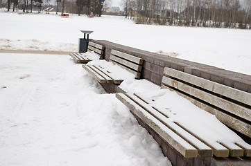 Image showing wooden park bench waste bin cover snow in winter 