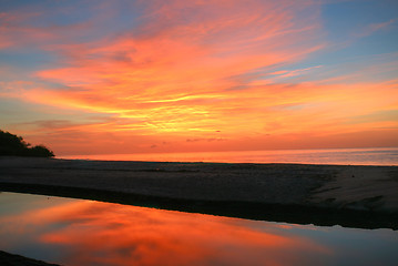 Image showing Sunrise over the pacific ocean and the end of the lake with refl