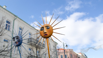 Image showing march goes city street people carry sun figures 
