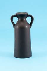 Image showing old ceramic vase with two handle blue background 