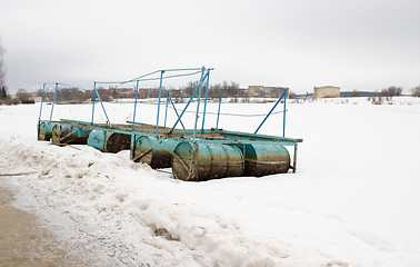 Image showing quay dock old steel barrel snow lake shore winter 