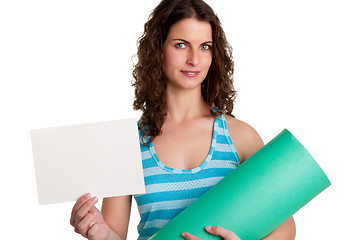 Image showing Woman Holding a Mat and a White Empty Card