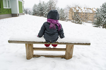 Image showing child with gray jacket sitting on bench in winter 