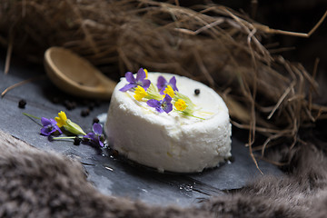 Image showing Goat cheese and spring flowers