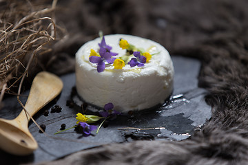 Image showing Goat cheese and spring flowers