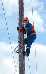 Image showing electrician climbs a power pole