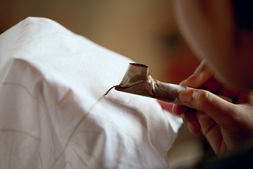 Image showing Making batik process. Application of wax on fabric