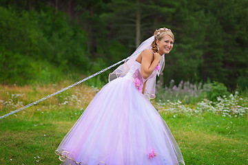 Image showing Bride pulls a steel chain