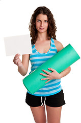 Image showing Woman Holding a Mat and a White Empty Card