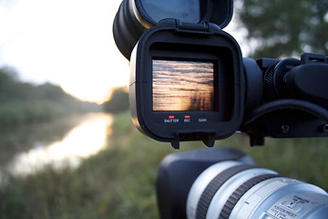 Image showing A videocamera filming river