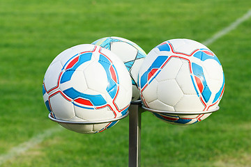 Image showing three football bals on holders