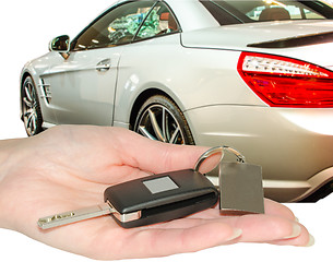 Image showing Female hand of new car owner holding auto keys isolated
