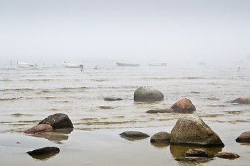 Image showing Old fishing boat at coast foggy in the morning