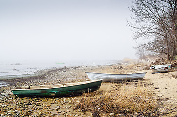 Image showing Old fishing boat at coast foggy in the morning