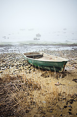 Image showing Old fishing boat at coast foggy in the morning