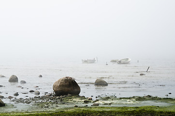 Image showing Old fishing boat at coast foggy in the morning