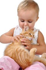 Image showing baby child playing with a kitten