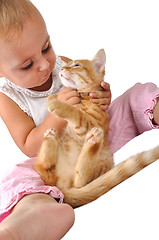 Image showing toddler child plays with a cat