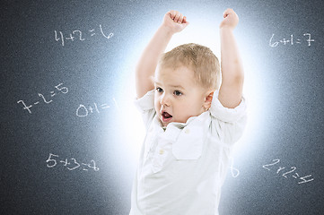 Image showing Little boy against a school blackboard