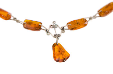 Image showing amber stone blurred necklace isolated on white 