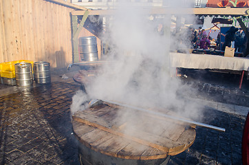 Image showing people hot drink wine big pot smoke fair market 